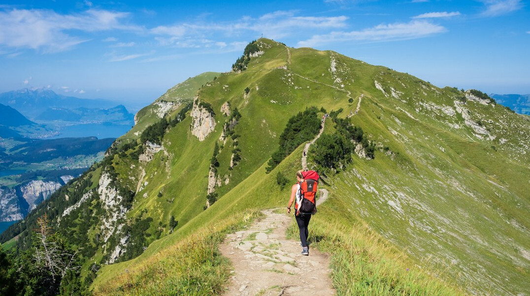 person walking on mountain path